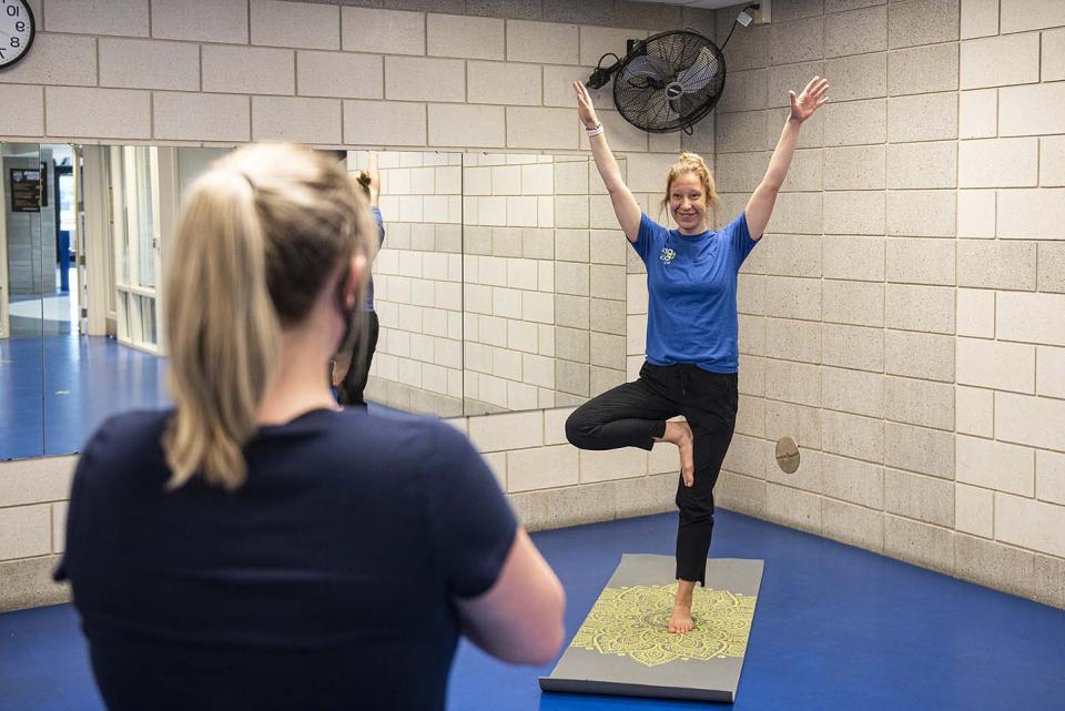 Employee health coach Lindsay Bloom leads a yoga class