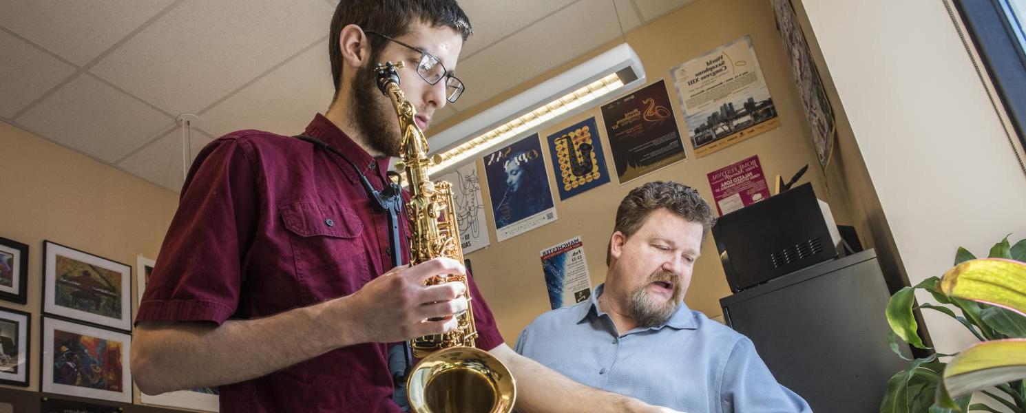 Professor teaching a saxophone student.